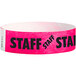 A pink paper wristband with black "STAFF" text.
