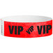 A red and white paper wristband with black "VIP" text.