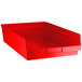 A red plastic shelf bin with a handle.