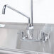 A stainless steel Equip by T&S add-on faucet on a sink.
