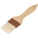 A 2" wide pastry brush with a wooden handle.