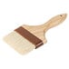A 4" wide boar bristle pastry brush with a wooden handle.