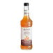 A bottle of Monin Zero Calorie Natural Pumpkin Spice flavoring syrup with an orange label.