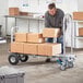 A man using a Lavex hand truck to move a box.