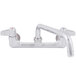 A chrome Equip by T&S wall mount faucet with 10 1/8" swing spout and lever handles.