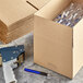 A Lavex Kraft corrugated cardboard shipping box on a grey surface.