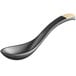 An Acopa black and ivory melamine soup spoon with a black handle.