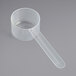 A clear plastic measuring cup with a long handle.
