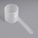 A clear plastic container with a clear plastic measuring scoop with a long handle.
