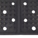 A black rectangular Cactus Mat with holes in it.