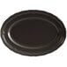 An Acopa Condesa matte black porcelain platter with a scalloped edge.