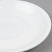 An Arcoroc white porcelain saucer with a rim.