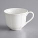 An Acopa Condesa pearl white porcelain cup with a handle.