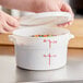 A white Choice round food storage container with a lid open, filled with colorful candies.