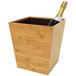 A Room360 natural bamboo wine cooler holding a bottle of champagne.