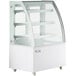 An Avantco white refrigerated bakery display case with curved glass doors on wheels.