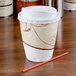 A white Solo Symphony foam cup with a straw next to it.
