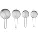 A group of stainless steel measuring cups with wire handles.