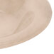 A close up of a GET Tahoe Sandstone bowl in beige on a white surface.