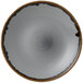 A Dudson Harvest grey china plate with a black center and brown rim.