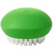 An OXO Good Grips green and white vegetable brush.