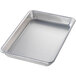 A close-up of a Chicago Metallic glazed aluminum sheet pan with a curled rim.
