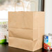 Duro Bistro Natural Kraft Paper Shopping Bag with Handles 10" x 6 3/4" x 12" - 250/Bundle Main Thumbnail 1
