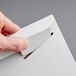 A person's hand opening a white Lavex Stayflats envelope