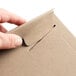 A person's hand opening a brown Lavex Stayflats rigid mailer box.