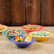 A table with colorful bowls of food, including a Rio orange bowl.