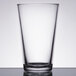 A close-up of a clear Libbey beverage glass on a table.