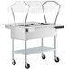 A silver ServIt electric steam table on wheels with a clear cover.