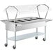 A ServIt open well electric steam table with a clear sneeze guard on casters.