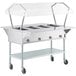 A ServIt commercial electric steam table with a clear cover over the food pans on wheels.