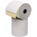 A close-up of a Point Plus 2-ply carbonless paper roll with a yellow strip.