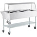 A ServIt stainless steel electric steam table on wheels with an angled glass sneeze guard.