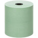 A roll of green Point Plus cash register paper on a white background.