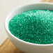 A bowl of Regal light green sanding sugar.