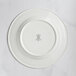 A white RAK Porcelain flat plate with an embossed design of a crown.