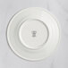 A white RAK Porcelain flat plate with a crown logo.