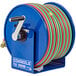 A blue Coxreels hand crank welding hose reel with a red handle.