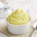 A bowl of yellow Creamery Ave. Pina Colada soft serve mix.