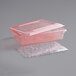 A red plastic container with a lid and a plastic tray.
