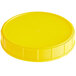 A yellow plastic lid for a 120 mm canister.