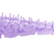 A close-up of a purple Lavex lavender scented gel urinal screen.