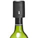 A Franmara Vino-Gauge wine preserver pump on a green bottle with a black top.