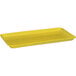 A yellow rectangular fiberglass MFG Tray on a counter.