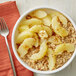 A bowl of oatmeal with Musselman's sliced apples.