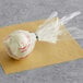 A white and red Chalet Desserts Red Velvet Cake Pop in plastic wrap.