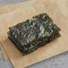 A piece of Kwangcheon roasted and seasoned seaweed on a plate.